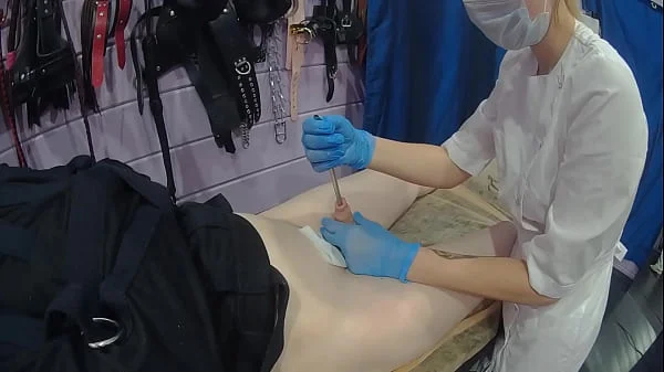 Medical fetish sounding in straitjacket