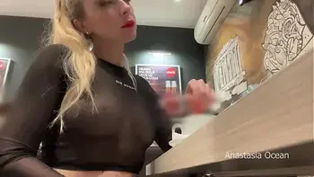 Flashing her big boobs in transparent top in public cafe.