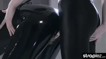Sexy domme fucks her latex clad lesbian lover with a strap on