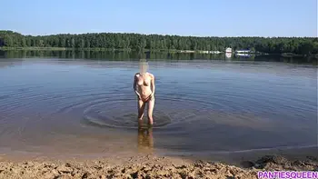 Naked girl goes skinny dipping in public beach