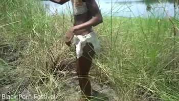 Skinny African tribe woman working outdoor