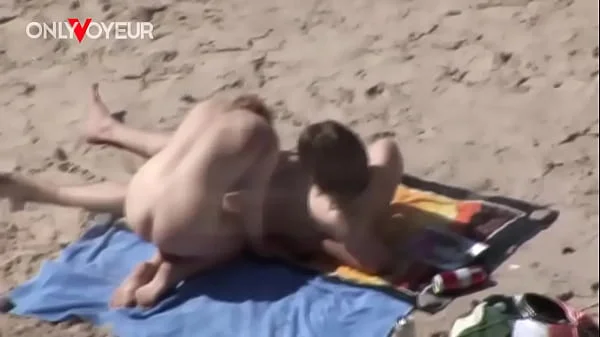 Beach Voyeur. Young nudist couple enjoying sex on the beach