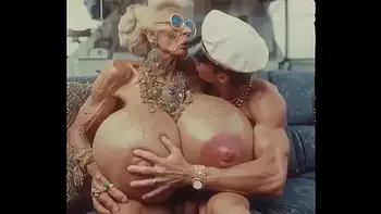 JAY7 Granny Boob Cruise 01 - AI VIDEO - A topless and horny granny with huge bolt-on tits gives a crazy titjob to the skipper