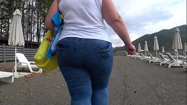 BBW with big booty in tight jeans is dressing in a public dressing room on the beach. Fetish.