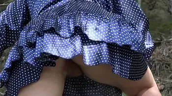 Under a skirt without panties. Hairy pussy and big ass in a short dress climbs mountains in nature.