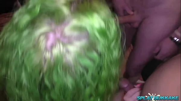 Tattooed stunner takes facials in a bukkake