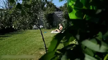 A NEIGHBOR SPIES ON A NAKED BIG-BOOBED NUDIST WOMAN