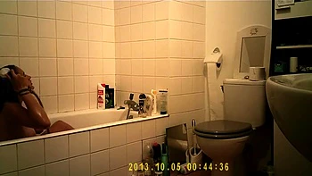 Brunette uses the toilet and takes a shower