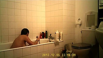 Brunette cutie enjoys a hot shower in the bathroom