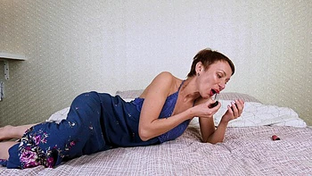 Short-haired milf plays with her pussy using a toy, achieving intense pleasure.