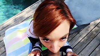Redhead Kaylee Haze sucks cock in steamy outdoor pool threesome